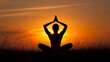 © Oulaphone - A silhouette of a person practicing yoga at sunset, showcasing peace, tranquility, and a connection with nature.