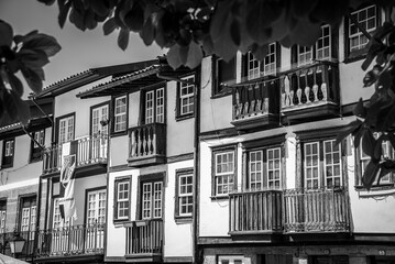 Wall Mural - Traditional wooden Portuguese house facade at Sao Tiago square in the city center of Guimaraes