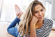 © peopleimages.com - Portrait, woman and apartment with smile on floor in living room to relax, rest and chill in France. Female person, home and happy or satisfied at lounge for self care, mindfulness and mental health