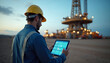© abu - A gas rig operator uses a tablet, blending traditional rig work with digital innovation.