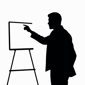 A businessman silhouette pointing towards a whiteboard