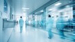 © Prapan - A blurred view of a modern clinic corridor with medical professionals in white coats walking through the hallway,