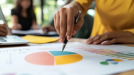 Poster - Close-up of a hand pointing at a pie chart on a financial document.