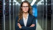 © Prapan - a female engineer with her arms crossed, positioned in front of a busy data center lined with servers. She has a strong, confident look,