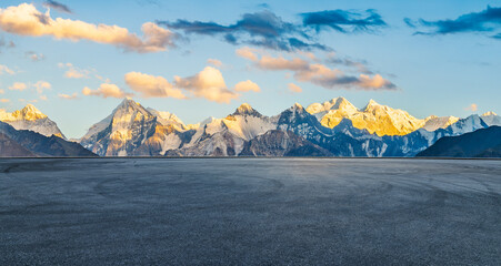 Wall Mural - asphalt road square and snow mountain natural landscape at sunset. car background.