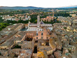 © AmazingAerialAgency - Aerial view of medieval Duomo di Siena cathedral surrounded by beautiful old town rooftops and historic architecture, Siena, Tuscany, Italy.