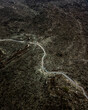 © AmazingAerialAgency - Aerial view of a walking path crossing a volcanic valley in Timanfaya National Park, Lanzarote, Canary Islands, Spain.