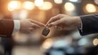 © night - Two people shake hands while one hands over the keys to a new car.