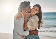 © peopleimages.com - Happy, kiss or couple hug at beach for love on vacation, valentines day or holiday in Spain. Interracial, relationship and people at sea for bonding together for romantic trip at ocean with smile