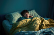 © romanets_v - Young man waking up in bed with yellow blanket in morning light feeling sleepy and reflective