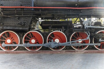 Mechanical wheels of a transport steam locomotive on rails