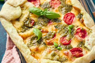 Wall Mural - Galette-type pie made from puff pastry and filled with tomatoes, mozzarella cheese and pesto sauce. Galette Caprese