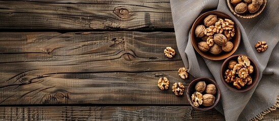 Wall Mural - Top view of bowls with walnuts set on a wooden backdrop offering plenty of space for additional content like text or graphics in the copy space image