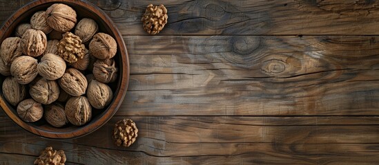 Wall Mural - Wooden background with a bowl of walnuts providing copy space image