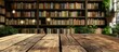 © Ilgun - A wooden table is set against a blurred school or university library backdrop offering plentiful copy space for product advertisements amid a lovely array of books