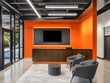 © Agus - Orange walls combined with light gray seating and black accents in a sleek, modern receptionist area for a vibrant, contemporary look