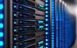 © tonstock - High-tech server room featuring racks of servers with glowing blue lights, representing advanced technology and data storage solutions.