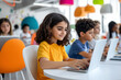 © SnapVault - A young girl concentrates on her laptop in a modern classroom filled with attentive classmates. Creative and interactive learning environment, concept of developing digital skills among students.