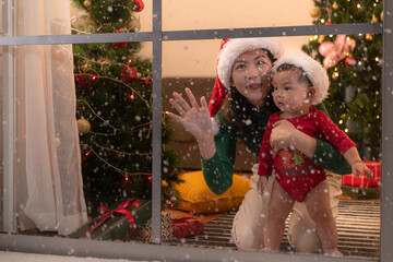 Mother and son relax on a snowy Christmas night