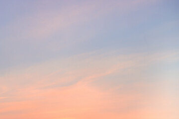 Wall Mural - A beautiful sky tinted by the sun leaving vibrant shades of gold, pink, blue and multicolored. Clouds in the twilight evening and morning sky. Cloudy sky background in the evening, and during the day.