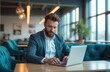 © Pavel Lysenko - A man in a suit working on a laptop at a modern office space with large windows and stylish furniture during the day