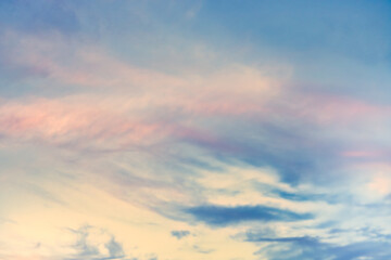 Wall Mural - A beautiful sky tinted by the sun leaving vibrant shades of gold, pink, blue and multicolored. Clouds in the twilight evening and morning sky. Cloudy sky background in the evening, and during the day.