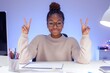 © Mark - A happy employee sits at her office desk meditating with her eyes closed, focusing on positive feelings and emotions before starting a productive workday.