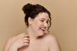 © Bliss - A plus size woman with curly hair radiates joy and confidence in a neutral backdrop.