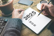 © ARAMYAN - New year resolutions 2025 on desk. 2025 goals list