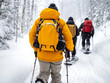 © EmmaStock - A traditional Canadian snowshoe trek through a snowy forest, with friends enjoying an outdoor adventure.