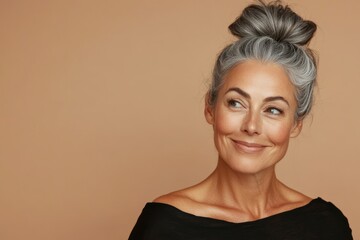 A mature woman with a serene smile and gray hair styled in an updo against a beige background. She exudes confidence and elegance, embodying graceful aging. Generated AI