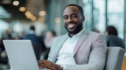Poster - A man wearing a suit and smiling while holding a laptop