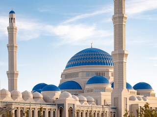 The main central mosque of Astana, with its striking blue domes and tall minarets, beautifully showcases Kazakhstan's rich culture and intricate architectural details against a bright sky