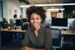 © Baba Images - Smiling portrait of a young hipster African American woman in office