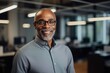 © NikoG - Smiling portrait of a senior African American businessman in modern office