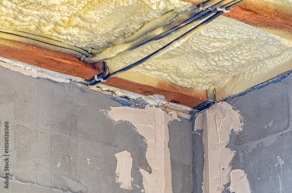 View of ceiling of building with insulation pipes running through it ...