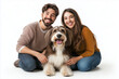 © Hoss - happy pet owners hugging their dog, portrait of a terrier with a coupl  proudly posing with their pet. Isolated on white, pet adoption, pet parents