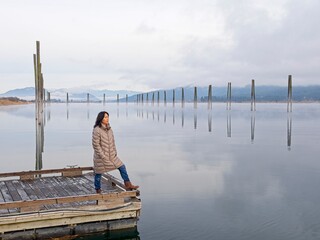 On the dock looking at the calm river.