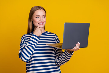 Photo of lovely charming woman wear striped stylish clothes use netbook isolated on yellow color background