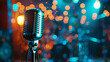 © Mahemud - Closeup of retro microphone on stage with a bokeh light backdrop. Karaoke or concert concept.