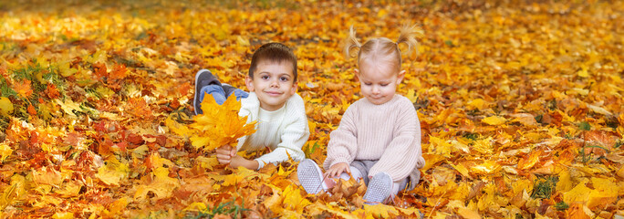 Happy children, boy and little girl in autumn park. Autumn