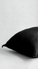   Black cushion rests atop white desk alongside black liquid container