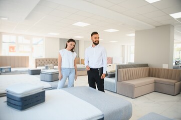 A sales consultant in a furniture store helps a female customer with a choice