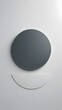 © Jim - Minimalist design with a round grey object and curved glass on a white background. Generative AI