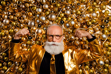 top view photo of senior old man raise fists up strong muscles lying christmas tree decor wear foil 