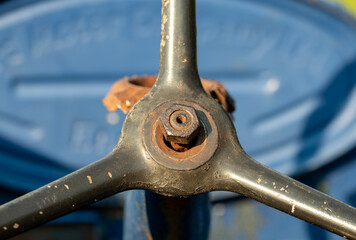 close up of an rusty bolt on tractor steering wheel