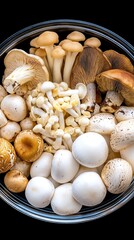 A top view of an elegant bowl showcasing an assortment of mushrooms like white button, shiitake, and portobello against a black backdrop