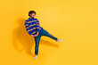 © deagreez - Full length photo of handsome young guy cute pose look empty space dressed stylish blue striped garment isolated on yellow color background