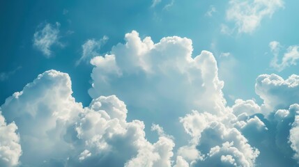 Wall Mural - Experience the serene beauty of a vast blue sky adorned with fluffy white clouds, a perfect backdrop for all seasons.
