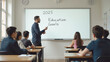 © 18042011 - A classroom scene featuring a teacher standing in front of a whiteboard displaying '2025 Education Goals', addressing attentive students seated at desks.